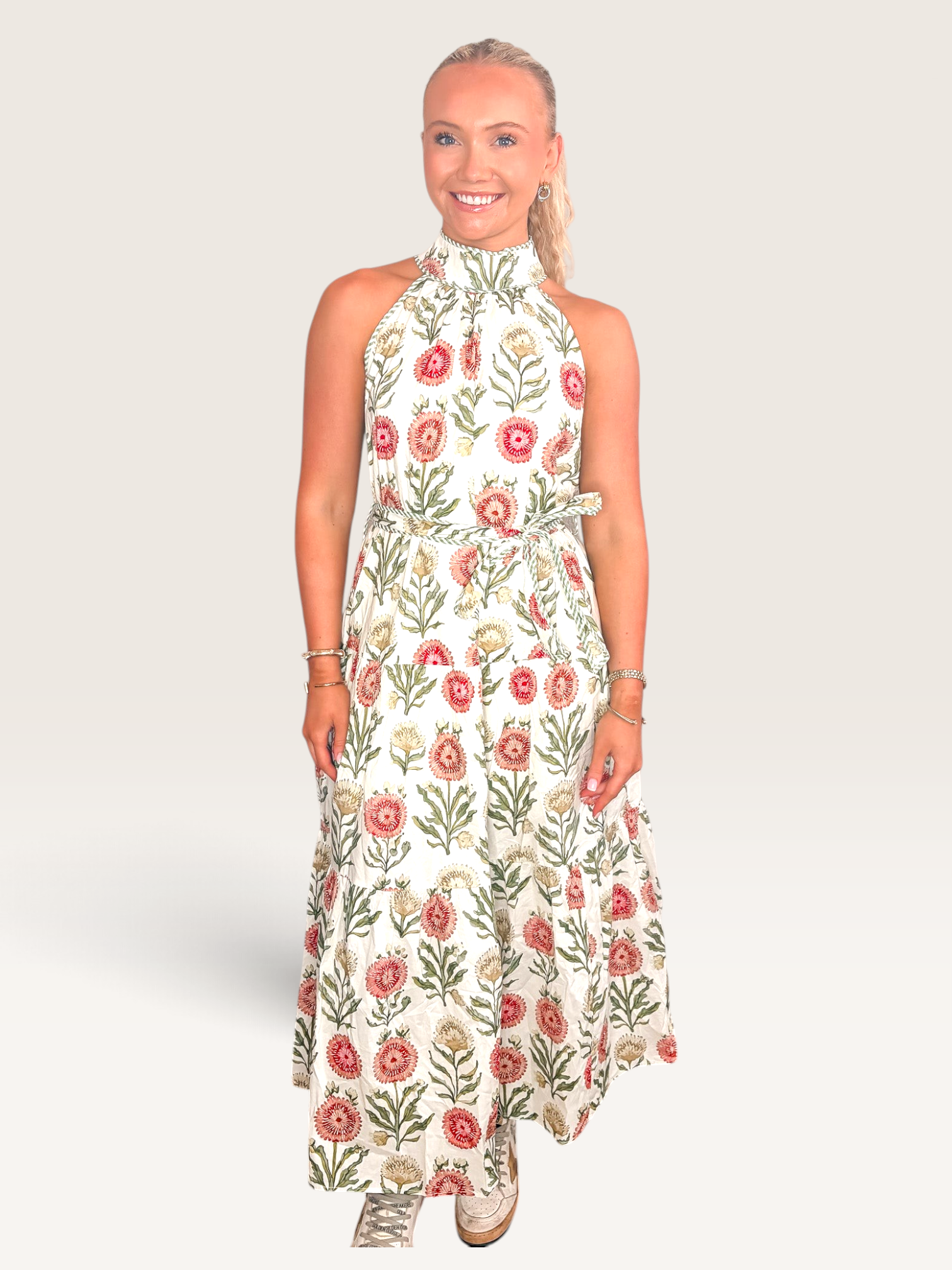 Tucker Brown sleeveless maxi dress in white with a vibrant red and green zinnia floral print and high halter neckline