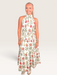 Tucker Brown sleeveless maxi dress in white with a vibrant red and green zinnia floral print and high halter neckline