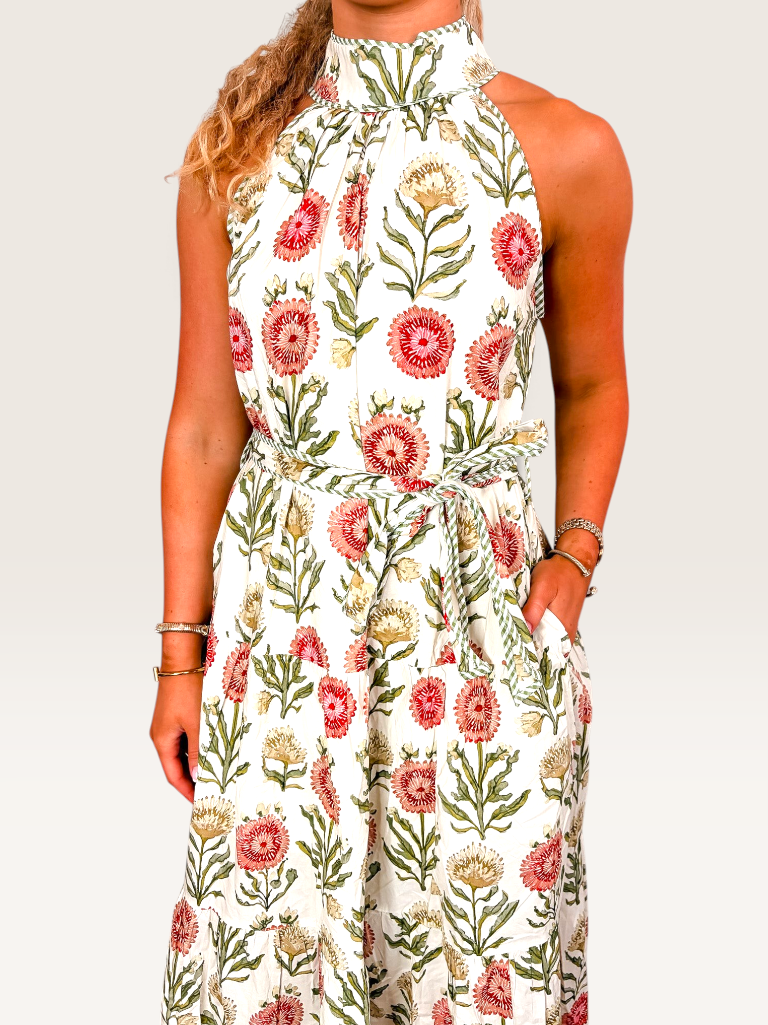Tucker Brown Zinnia floral maxi dress with a high halter neckline, sleeveless cut, and a matching waist tie belt.