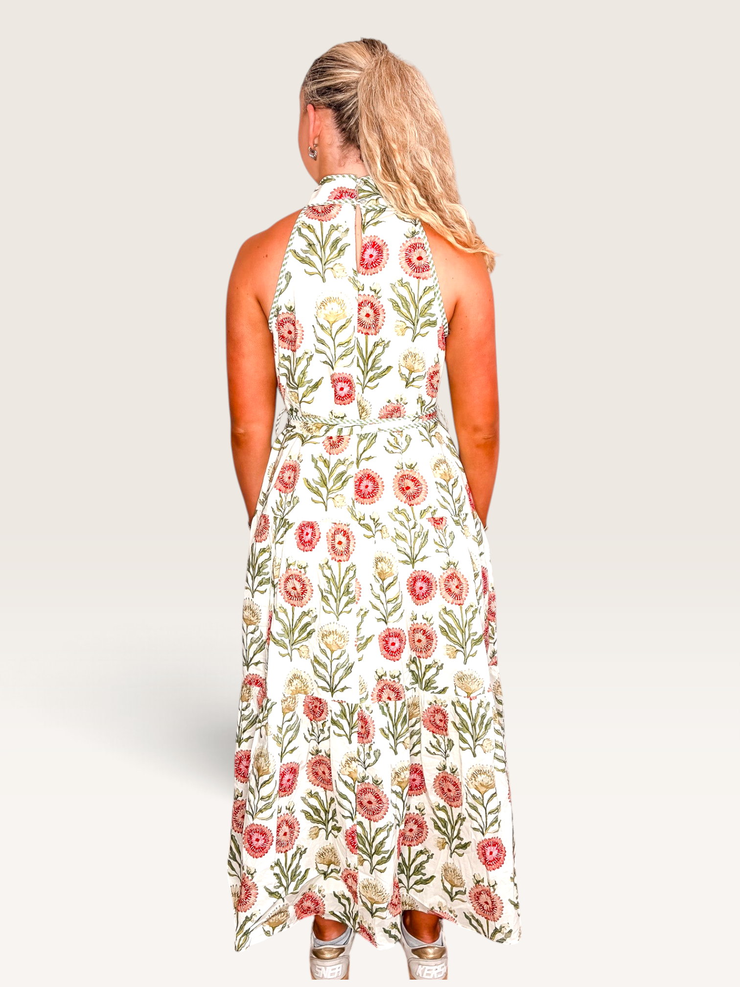 Tucker Brown Zinnia floral print maxi dress with a halter neckline and button closure, viewed from the back.