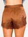 Tucker Brown brown satin shorts with floral eyelash lace trim and scalloped hem worn with cream cowboy boots