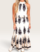 Tucker Brown Liza maxi dress in cream with black floral print, featuring a halter neckline and tie back detail.