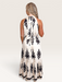 Tucker Brown Liza maxi dress in cream with black floral print, featuring a halter neckline and tie-back detail.