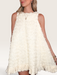 Tucker Brown white babydoll mini dress with eyelash ruffles, mock neckline, and textured fabric on a model
