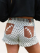 Tucker Brown high-waist shorts with white polka dots, brown football lace pockets, and striped waistband