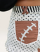 Tucker Brown high-waisted white polka dot shorts with brown football lace pockets and striped waistband detail