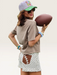 Tucker Brown high-waisted white polka dot shorts with brown football lace pockets worn on a football field