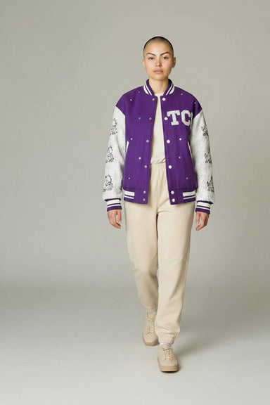 Tucker Brown TCU sequin bomber jacket in purple and white with Horned Frog mascot graphics and rhinestone accents.
