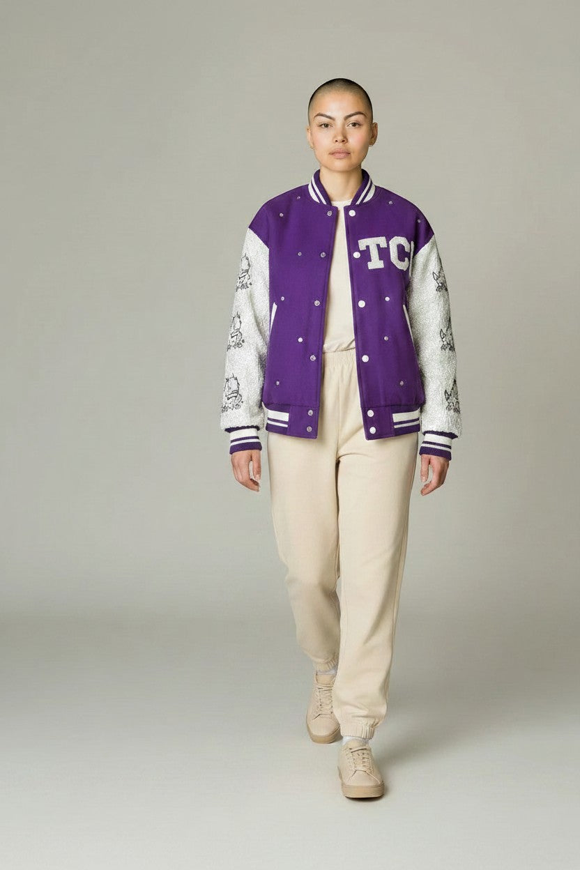 Tucker Brown TCU sequin bomber jacket in purple and white with Horned Frog mascot graphics and rhinestone accents.